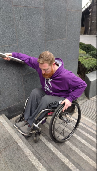 Pete demonstrates climbing stairs in a wheelchair
